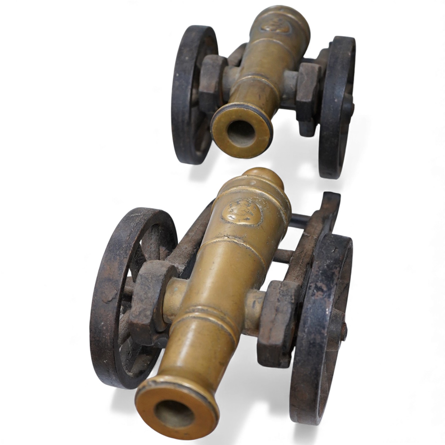 A pair of brass and cast iron model cannons, 34cm in length